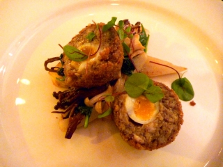 Neat and perfect quail egg surrounded by mushroom duxelles