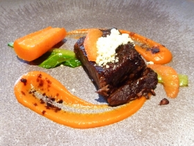 Dramatic plating for a lively flavour combination of coffee, beef, carrot and orange