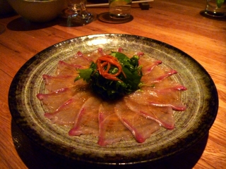 Yellowtail sashimi with truffle oil and poor lighting